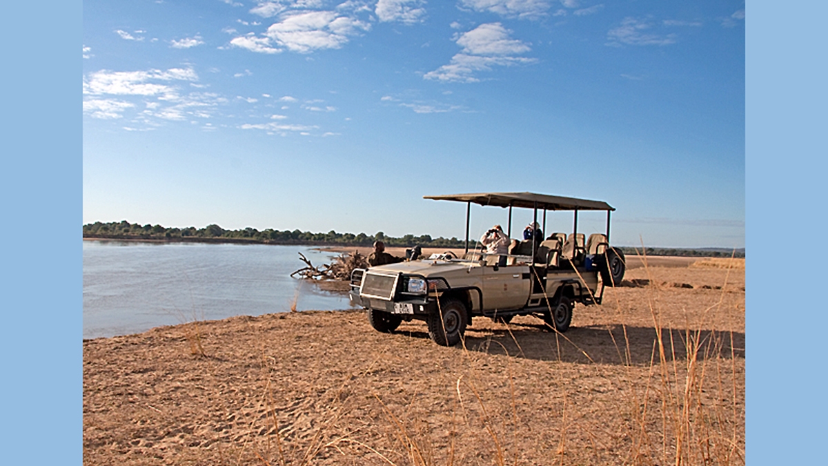 Game viewing vehicle on the banks of the Luangwa River
